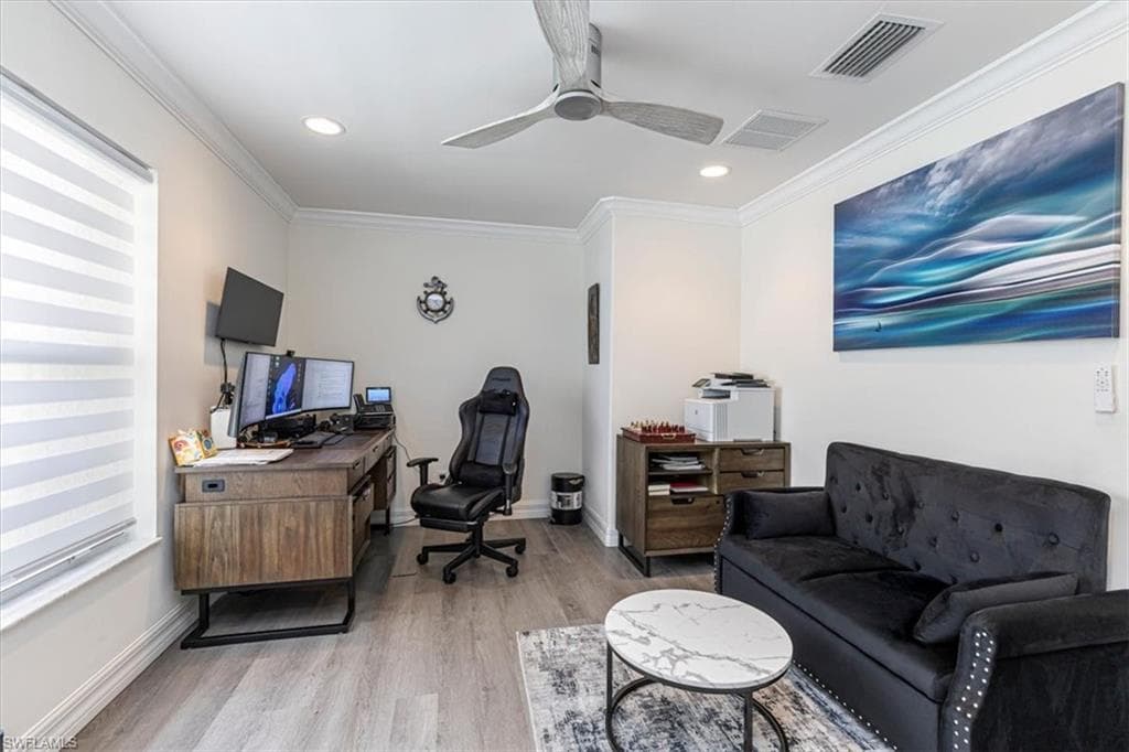 Office space featuring ornamental molding, light wood-style floors, a ceiling fan, and recessed lighting