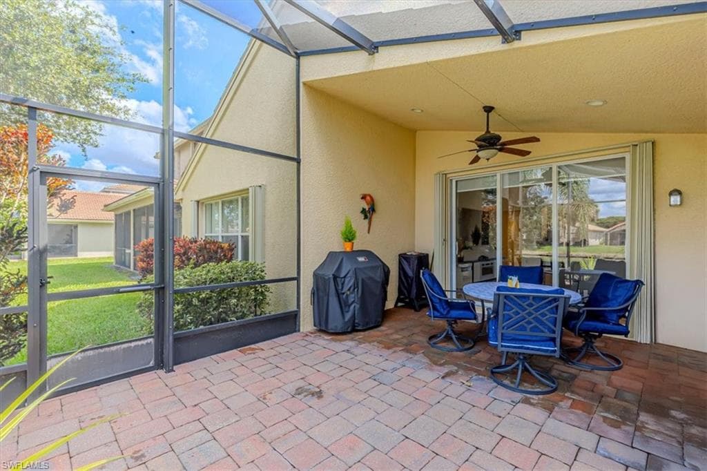 Sunroom with a ceiling fan, outdoor dining area, a patio area, and lofted ceiling