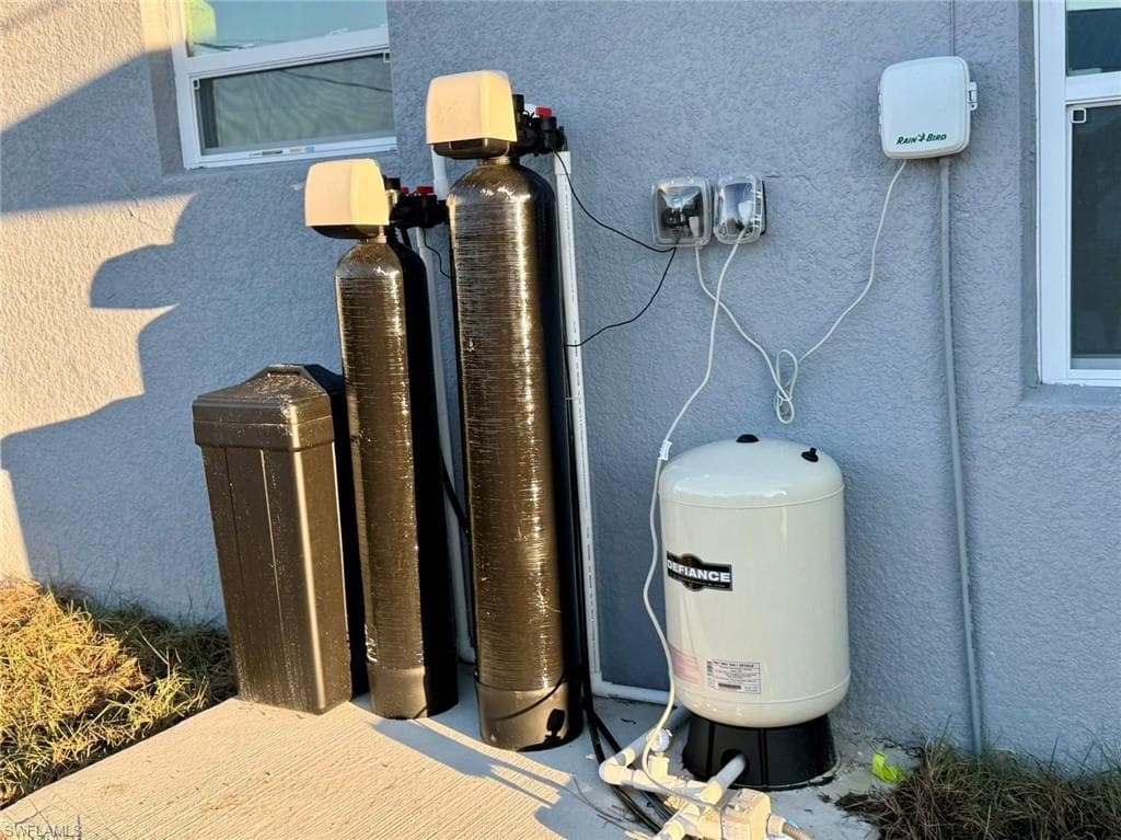 Exterior view of a water softener system and stucco siding