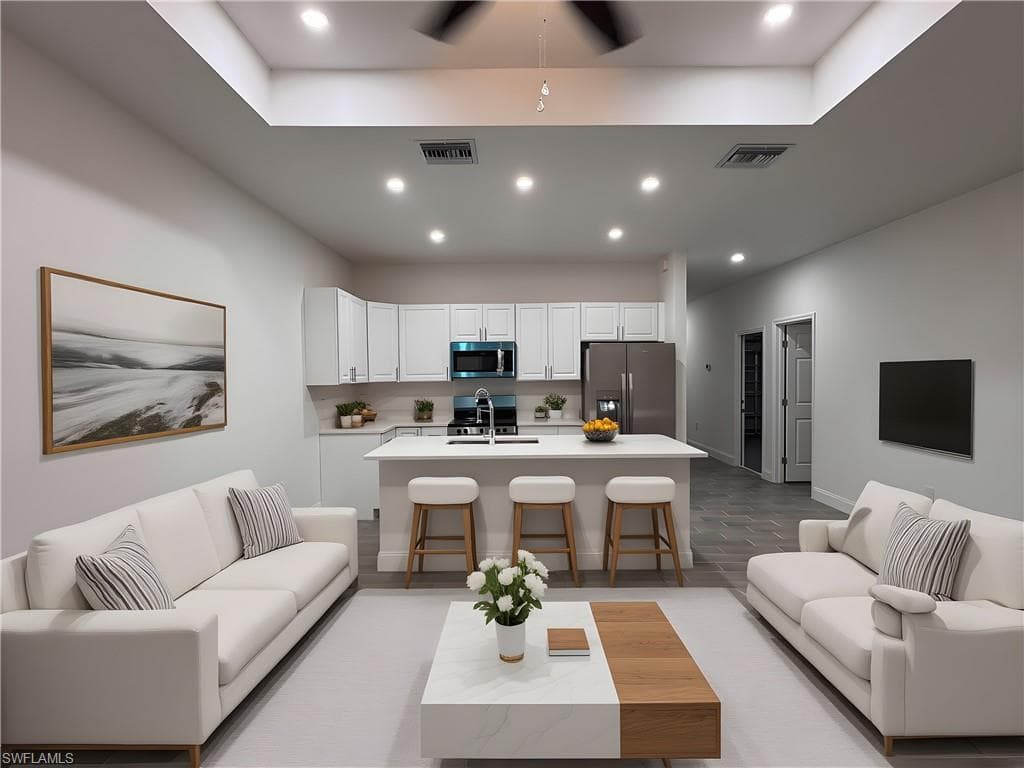 Living room featuring recessed lighting, light wood finished floors, and a ceiling fan