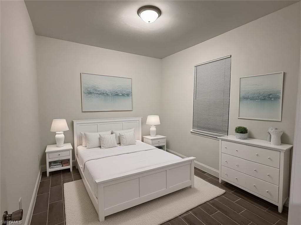 Bedroom featuring wood tiled floors and baseboards