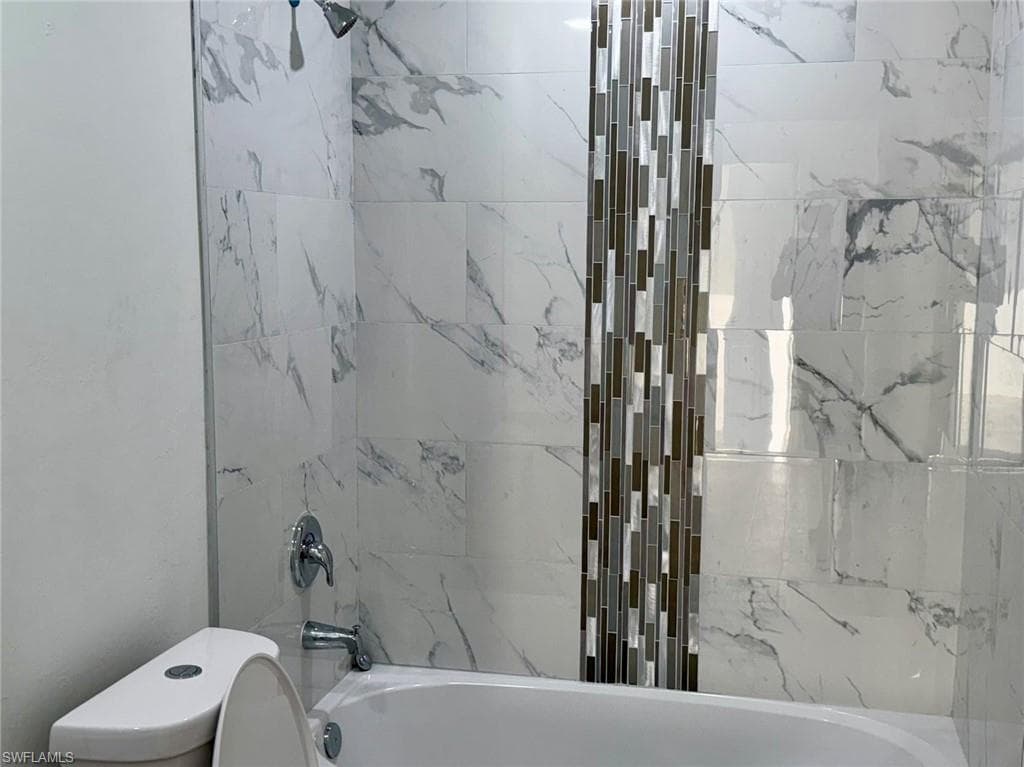 Full bath featuring tub / shower combination