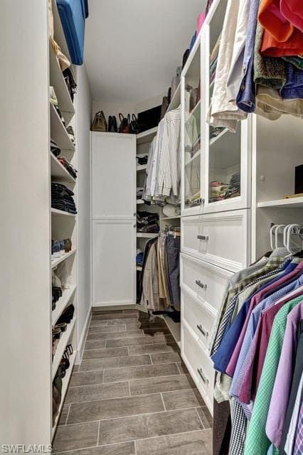 Primary custom built walk-in-closet.