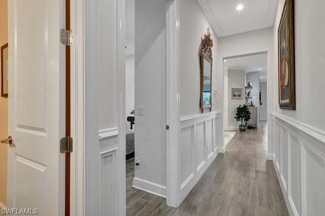 Hallway to (2) bedrooms, 2 bathrooms featuring wainscoting walls