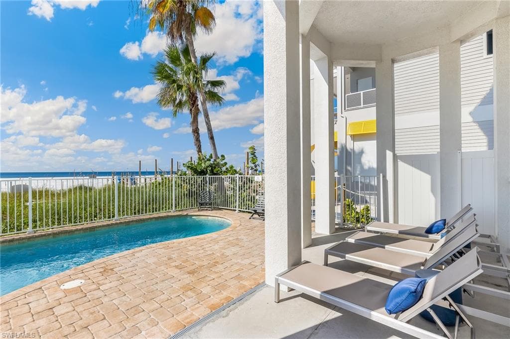 View of pool with a patio and a water view