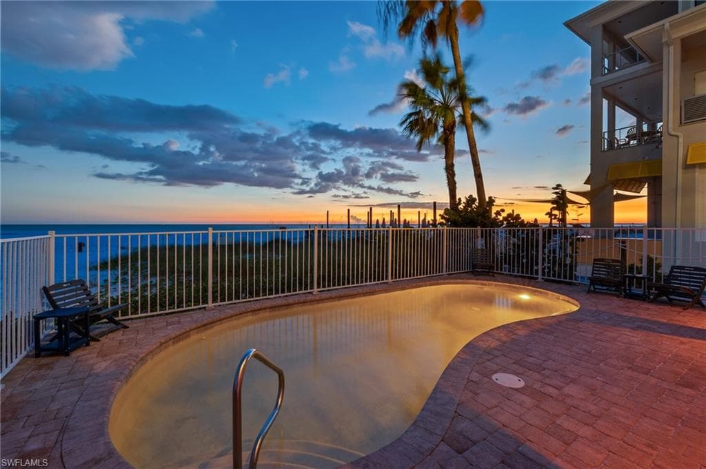 View of pool with area for grilling and a patio area