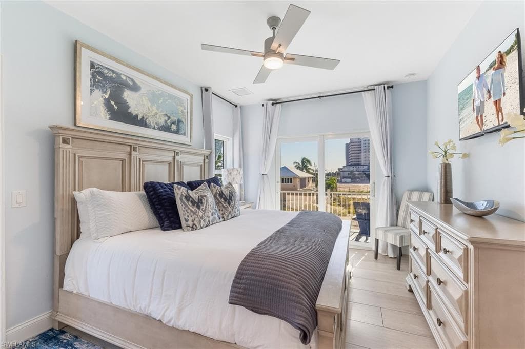 Bedroom featuring ceiling fan, access to outside, and light wood finished floors