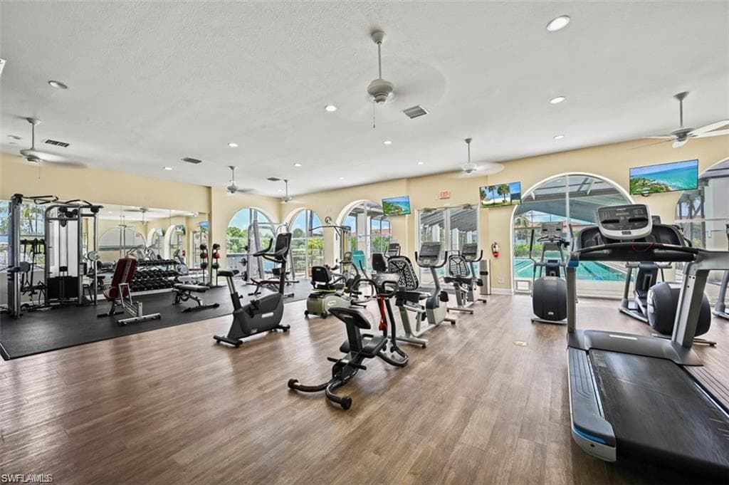 Workout area featuring ceiling fan and recessed lighting