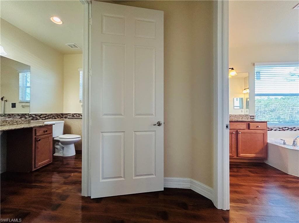 This a master bedroom with separate rooms / sinks to get ready.