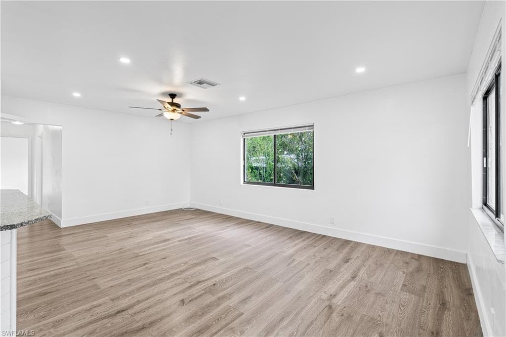 Spare room with recessed lighting, light wood finished floors, and ceiling fan