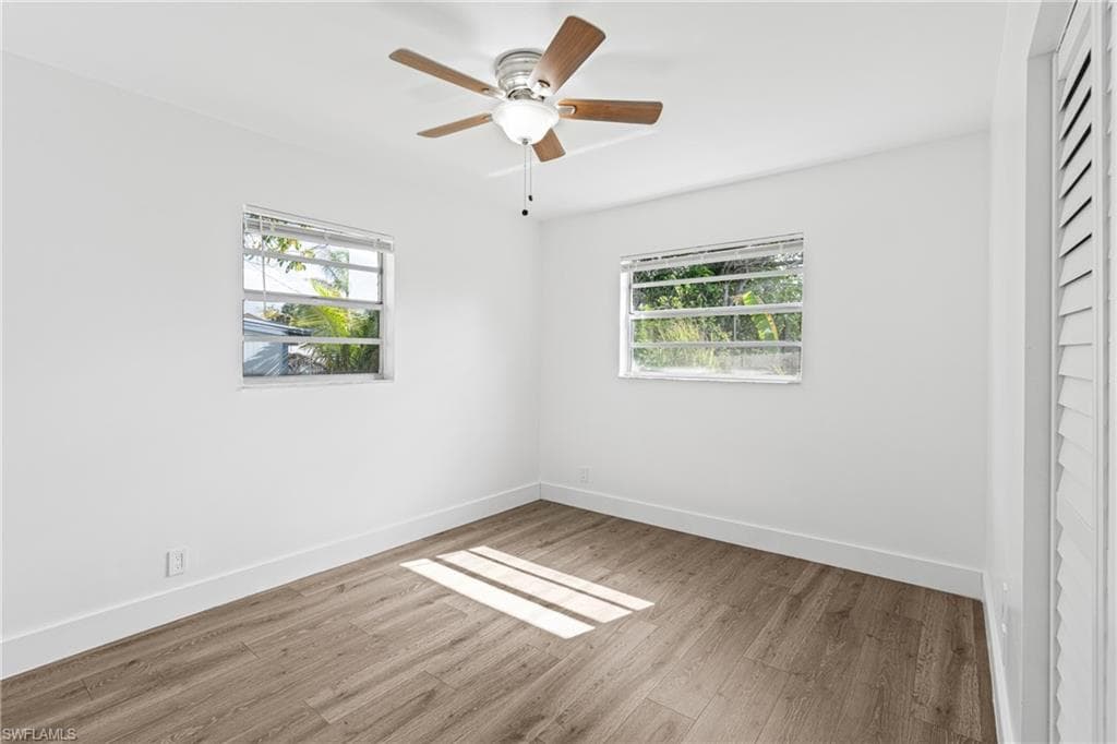 Empty room featuring light wood finished floors and ceiling fan