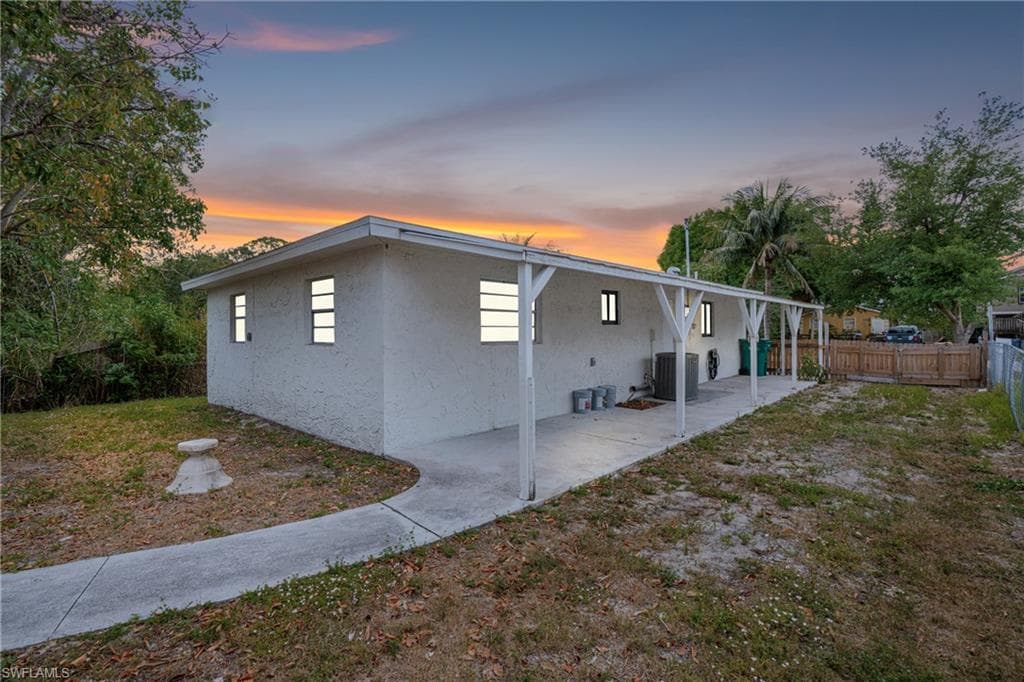 Back of property featuring stucco siding and a patio