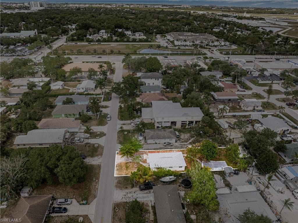 Aerial view of property and surrounding area with nearby suburban area