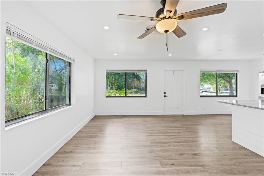 Unfurnished living room featuring recessed lighting, light wood-type flooring, and a ceiling fan