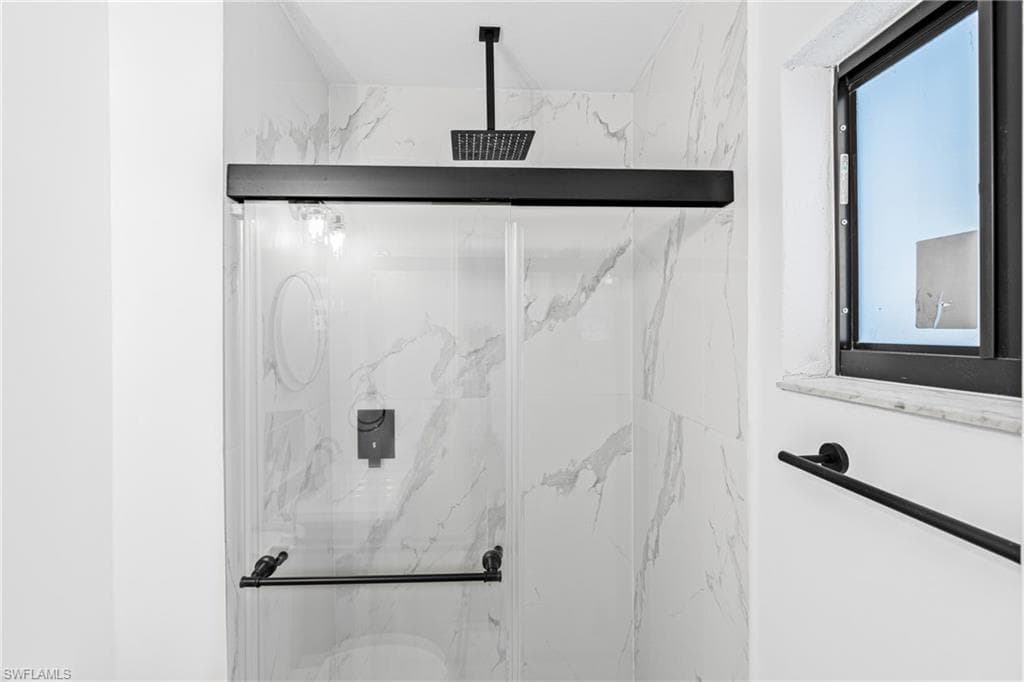 Bathroom view of a marble finish shower