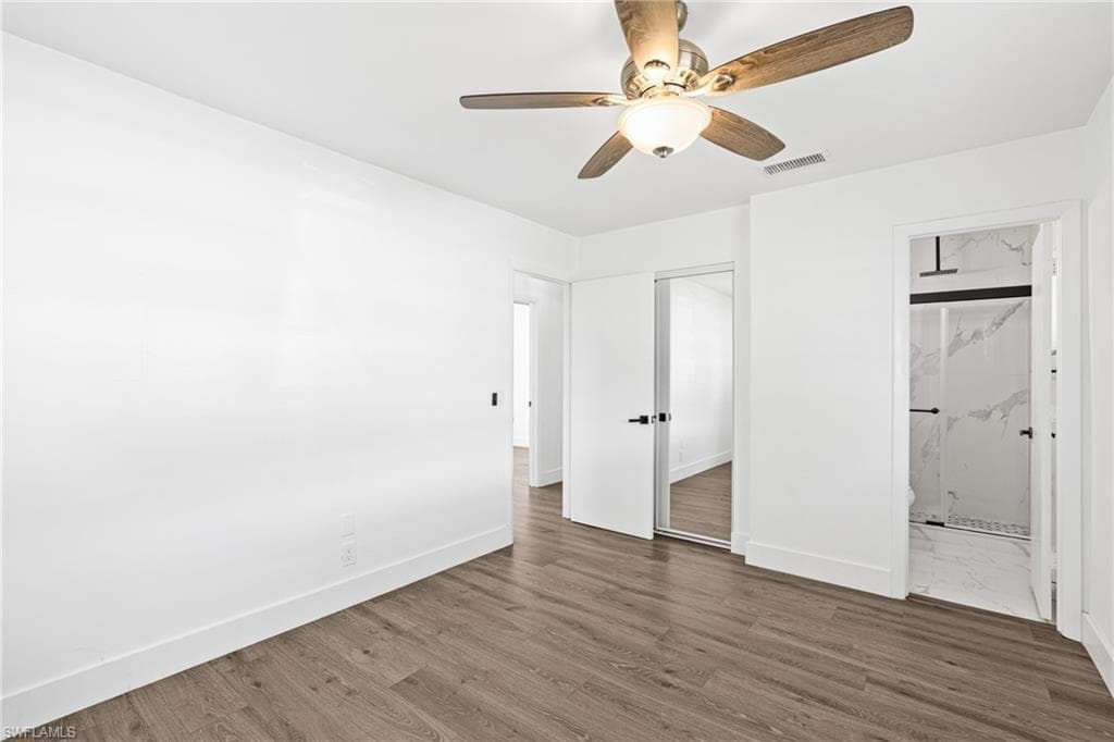 Unfurnished bedroom with a ceiling fan, a closet, and wood finished floors