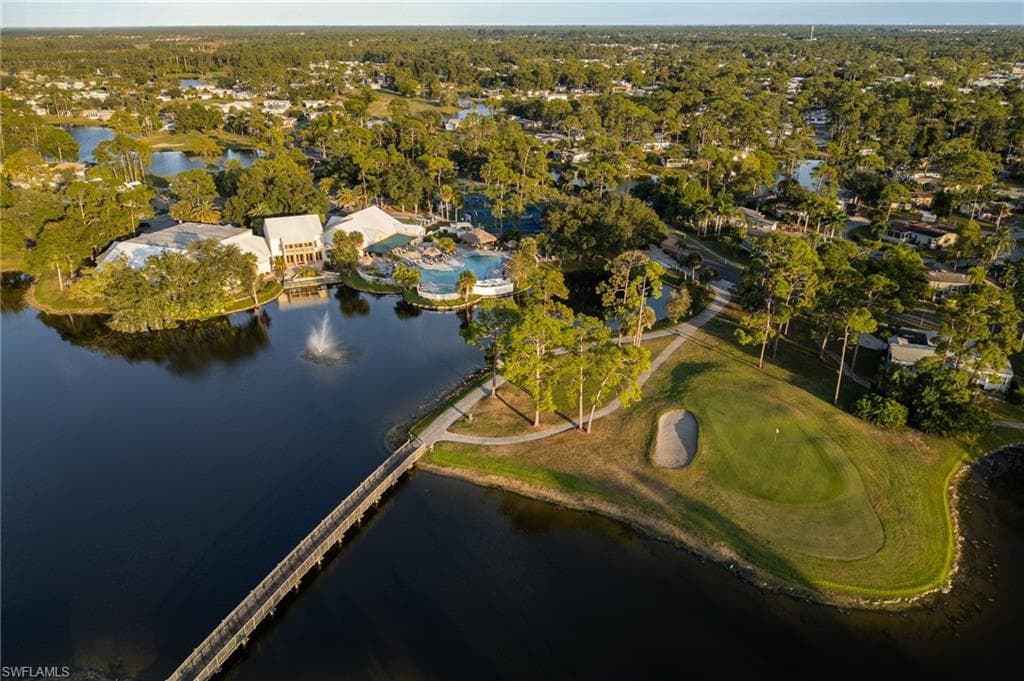 Aerial overview of property's location with a large body of water and a local golf course