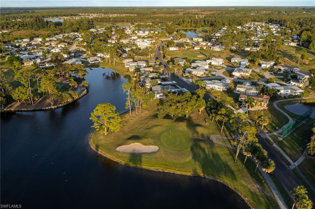 View of property location with a golf club and nearby suburban area