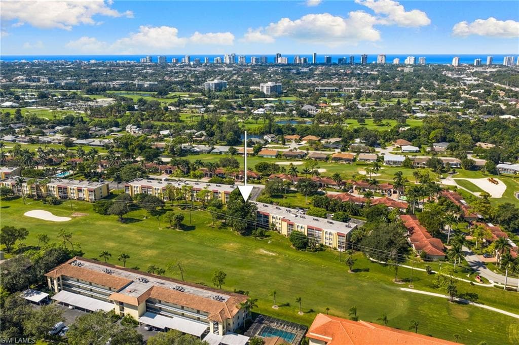 View of urban area with a local golf course and a large body of water