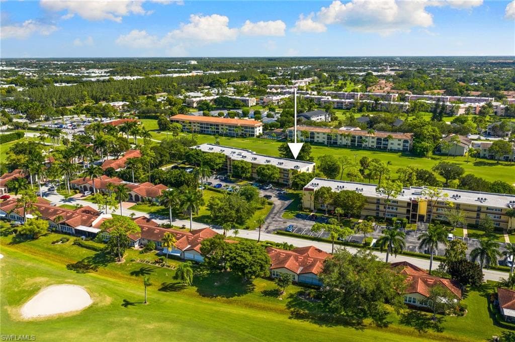 Drone / aerial view of a golf course and apartment complex