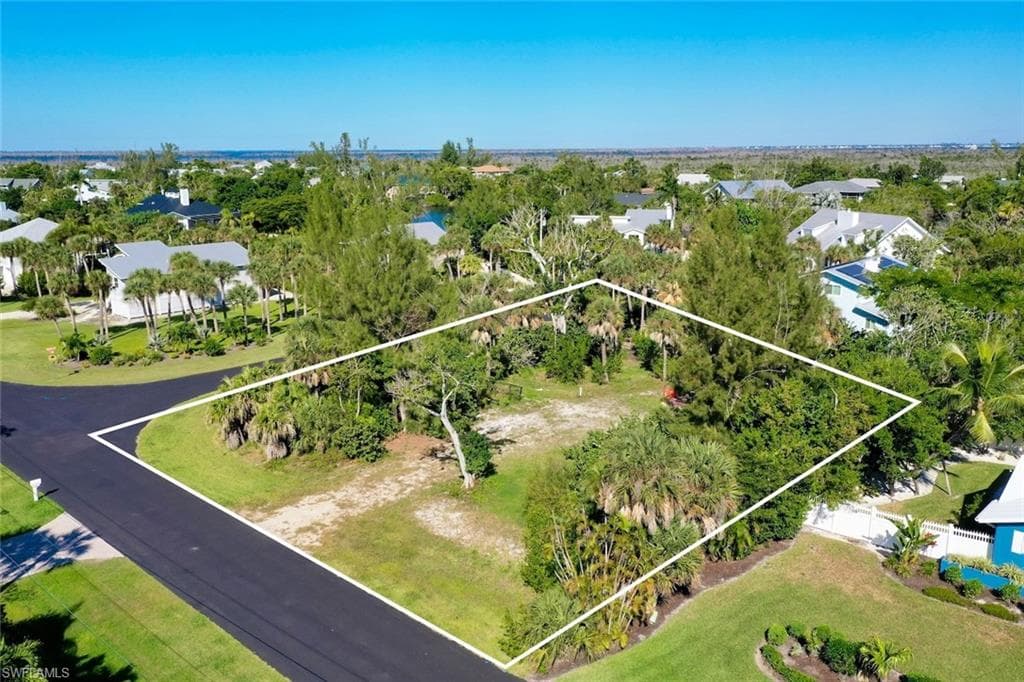 Aerial view of residential area featuring property boundaries highlighted