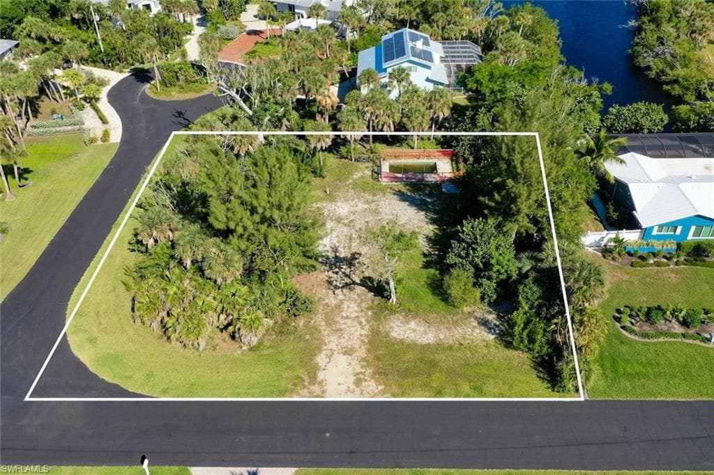 Aerial view of property and surrounding area with property parcel outlined