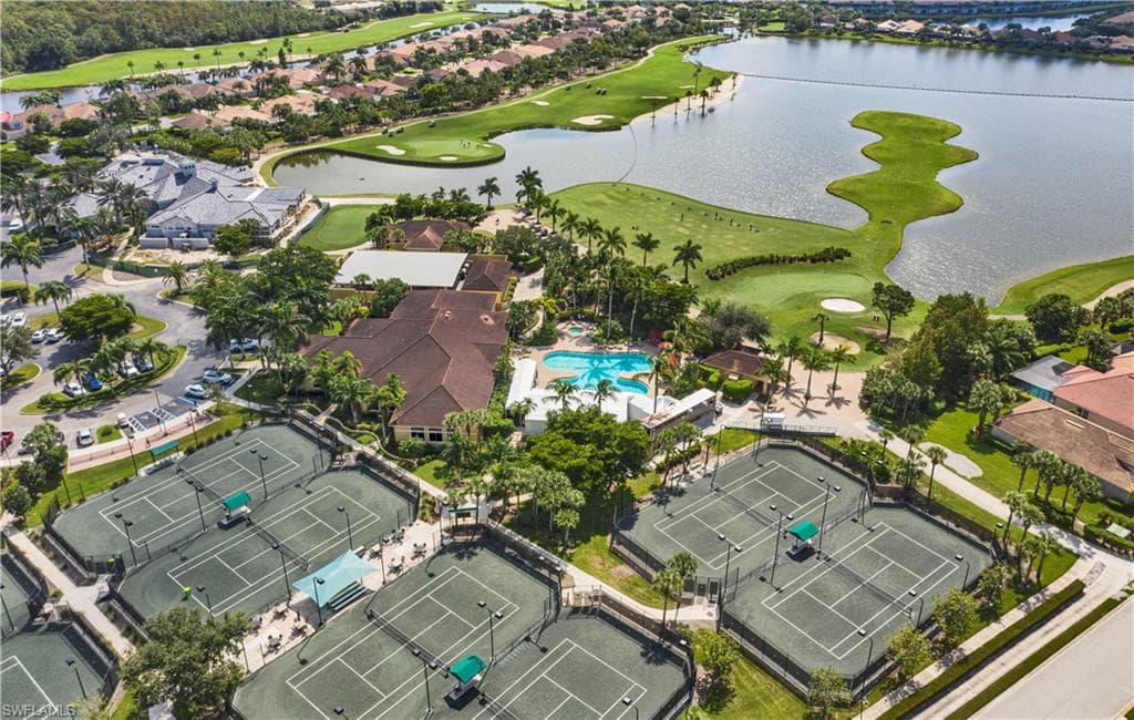 Aerial perspective of suburban area with a local golf course and a large body of water