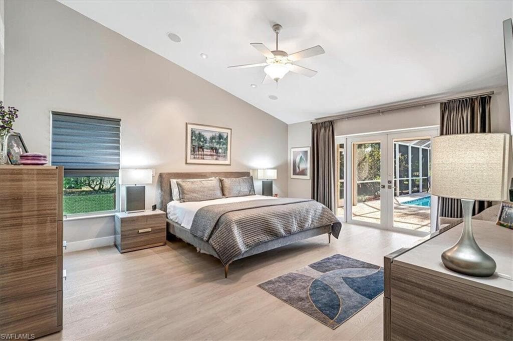 Bedroom with french doors, light wood-style floors, high vaulted ceiling, access to outside, and ceiling fan