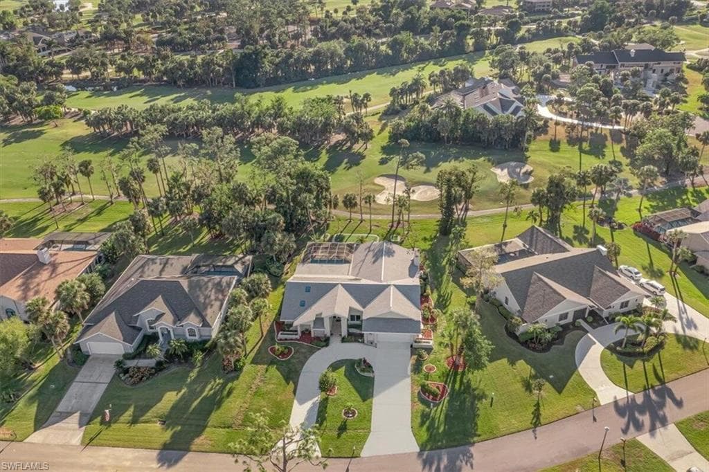 Aerial view of property and surrounding area with nearby suburban area and a golf club