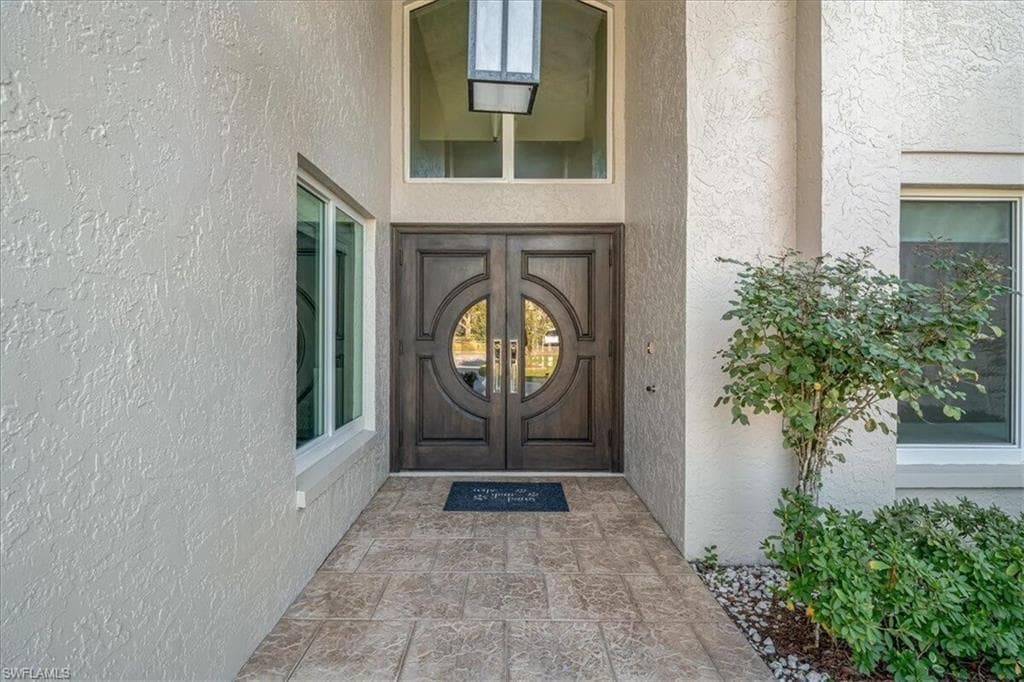 Doorway to property with stucco siding