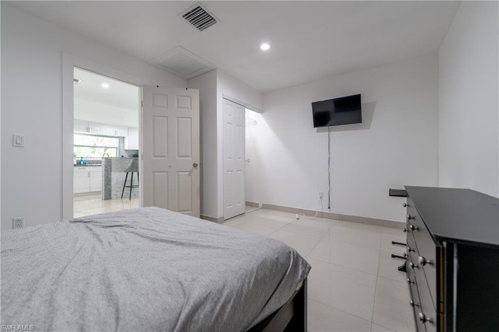 Bedroom with recessed lighting and light tile patterned flooring