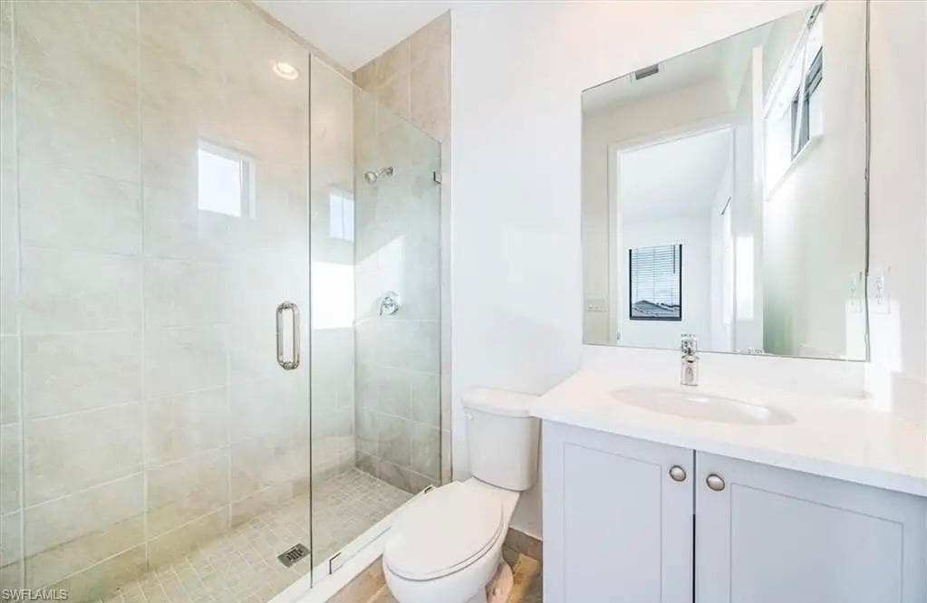 Bathroom featuring a shower stall and vanity