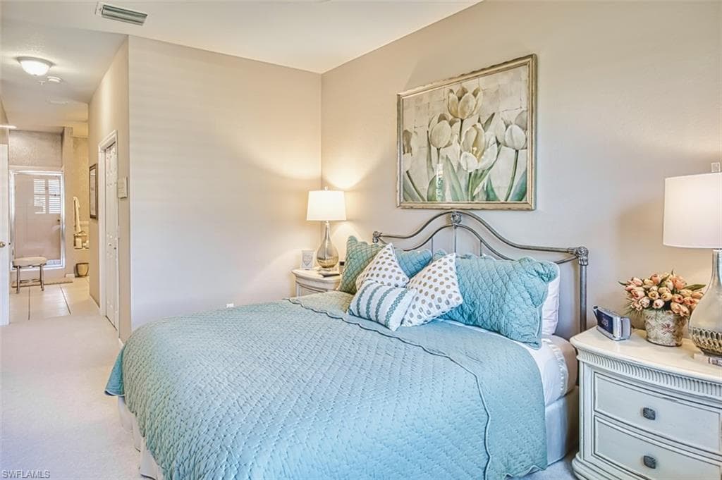 Carpeted bedroom with a closet