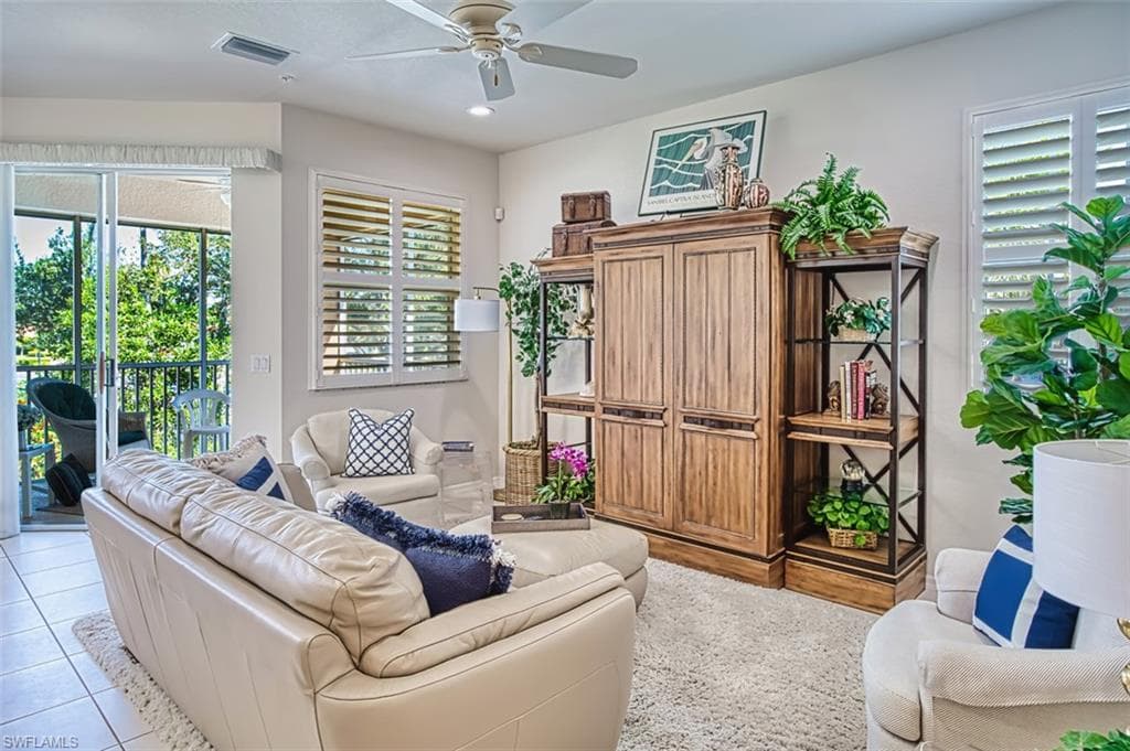 Living room with healthy amount of natural light, recessed lighting, a ceiling fan, and light tile patterned floors