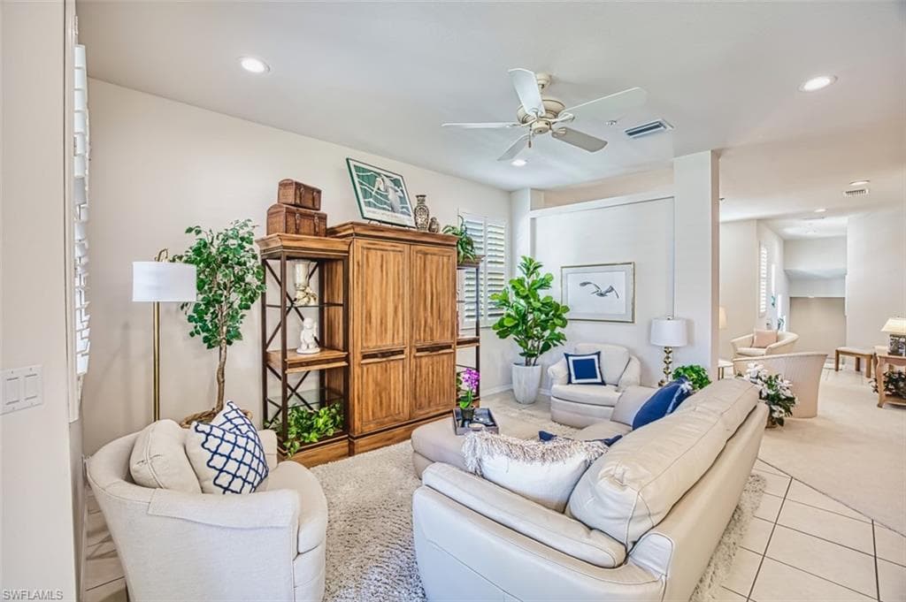 Living area featuring recessed lighting, light carpet, ceiling fan, and light tile patterned flooring