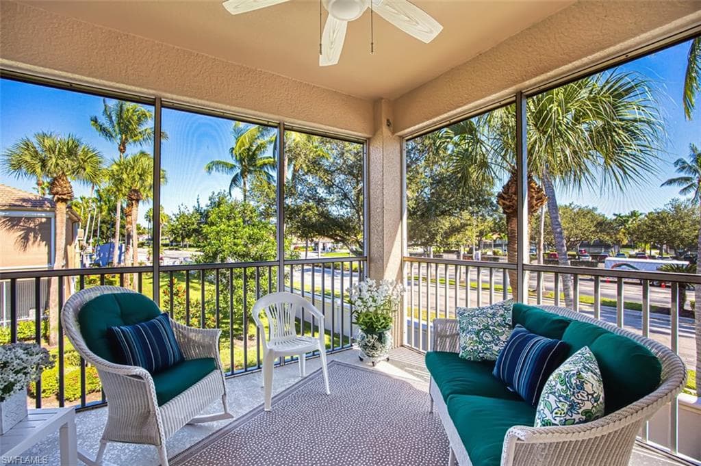 Sunroom / solarium with a balcony, ceiling fan, and healthy amount of natural light