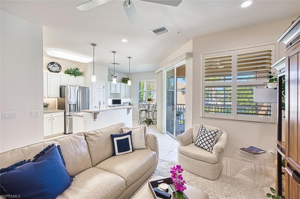Living room featuring light tile patterned flooring, recessed lighting, and a ceiling fan