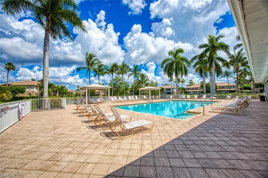 Community pool with a patio area and a gazebo