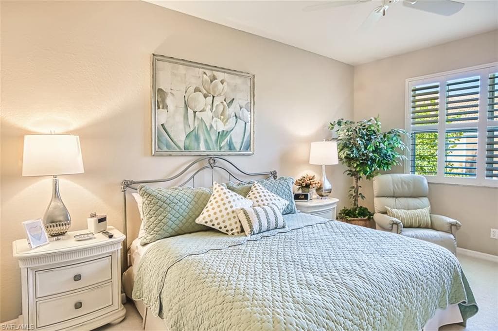 Carpeted bedroom with baseboards and ceiling fan