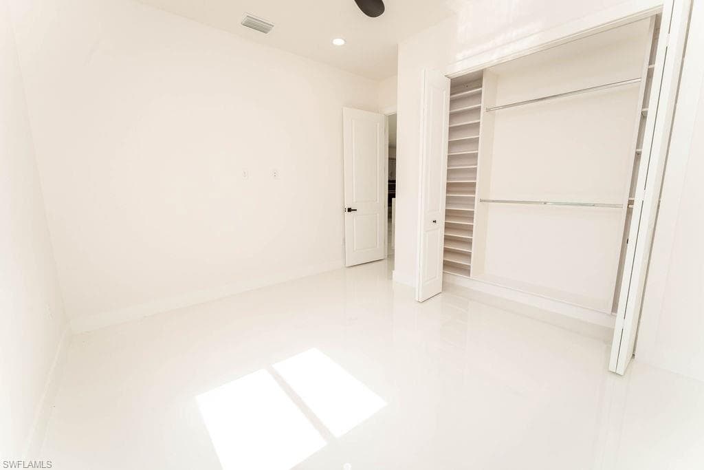 Unfurnished bedroom featuring a closet, recessed lighting, and ceiling fan