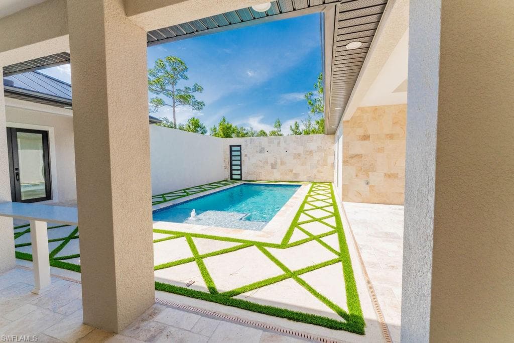 View of swimming pool featuring a patio area and a fenced backyard