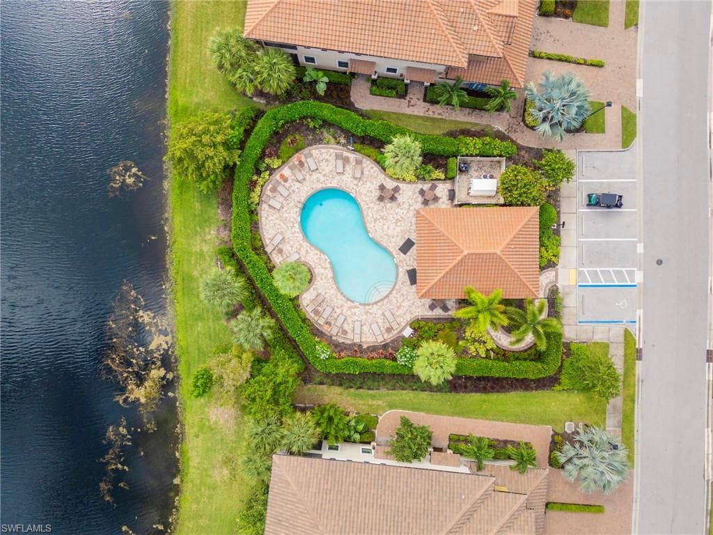 Drone / aerial view of a large body of water and a pool