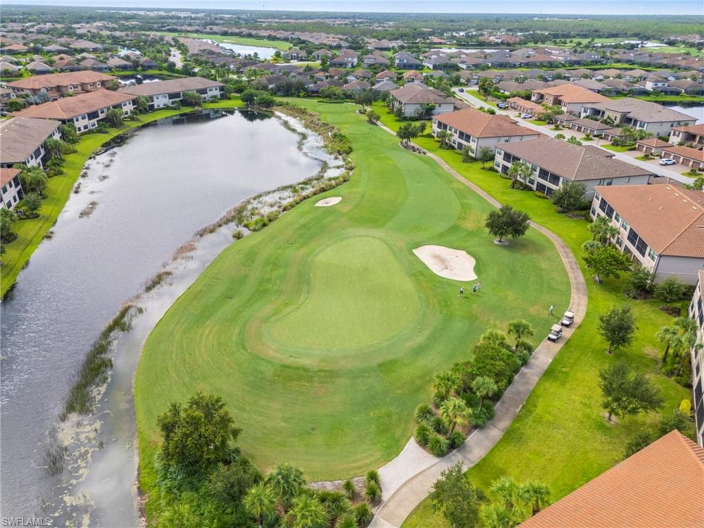 Aerial view of residential area with a large body of water and a golf course