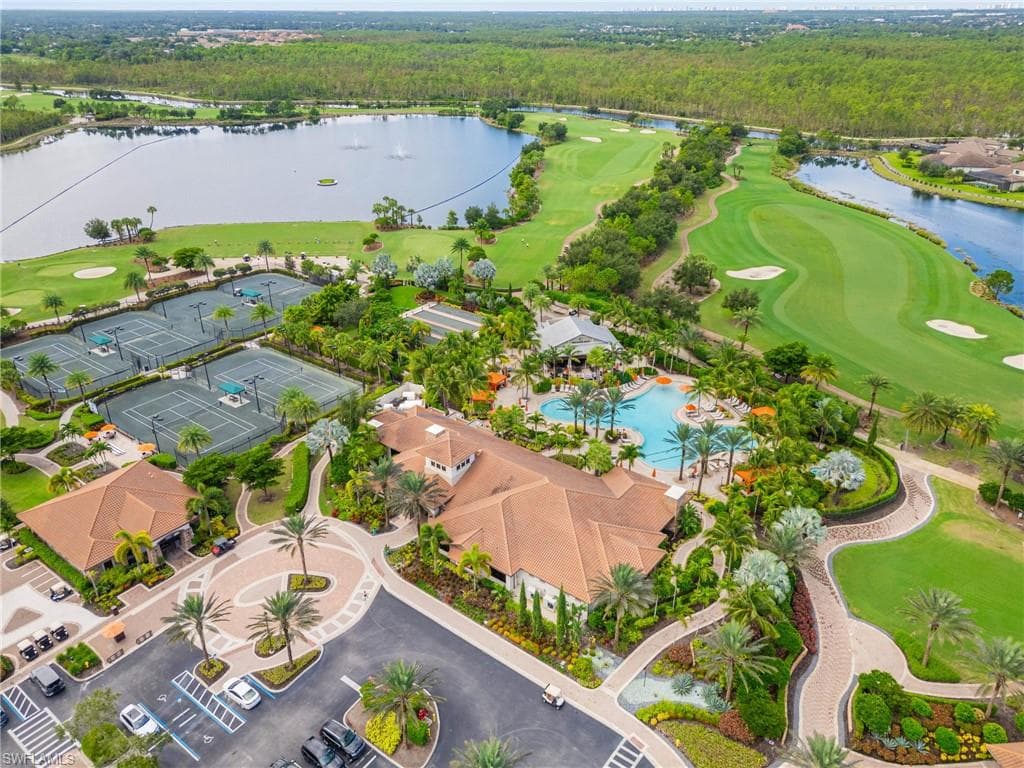 Drone / aerial view of a golf course and a nearby body of water