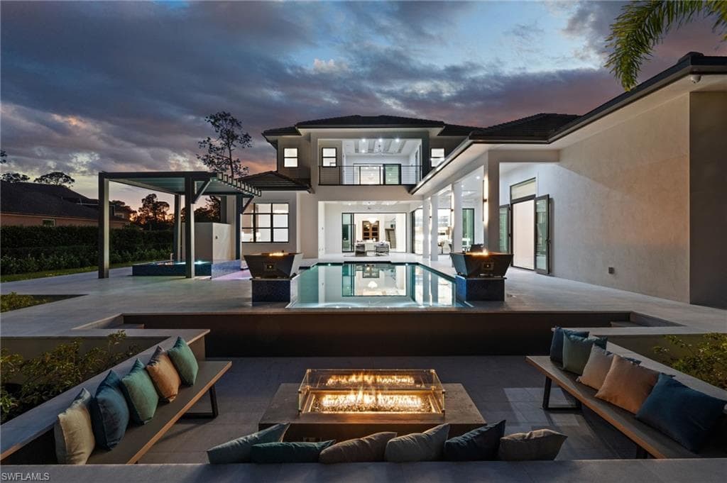 Backyard oasis with salt water pool, water features, fire-bowls and fire-pit seating area.