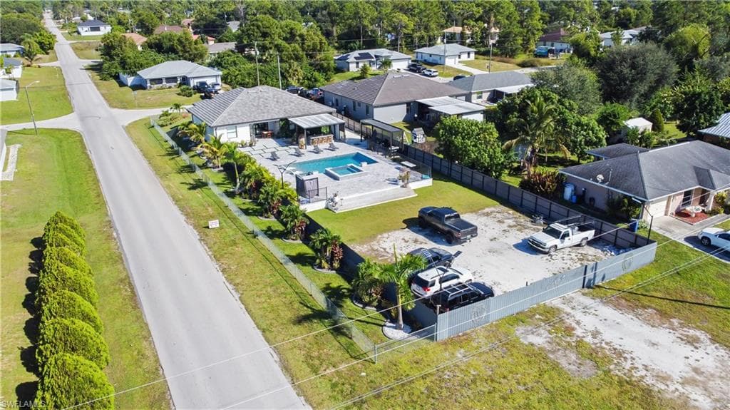 Aerial view of residential area featuring a pool area