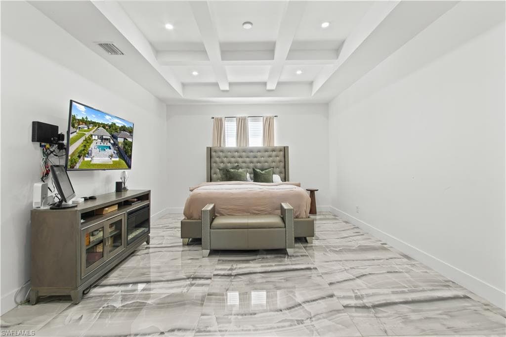 Bedroom with beamed ceiling, coffered ceiling, light marble finish floors, and recessed lighting