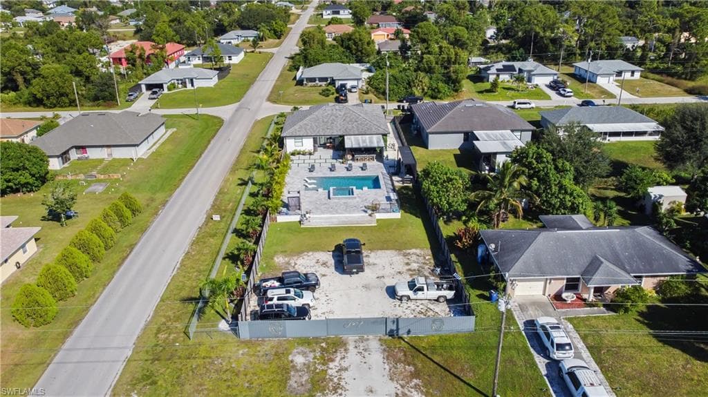 Aerial view of residential area featuring a pool