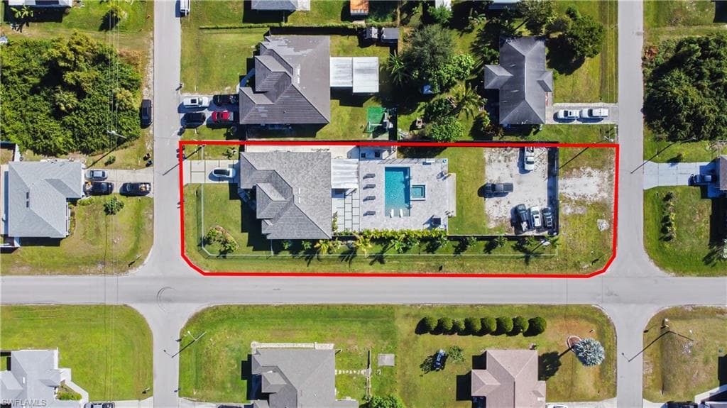 Aerial view of residential area featuring property boundaries highlighted