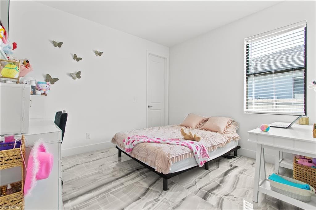 Bedroom featuring baseboards